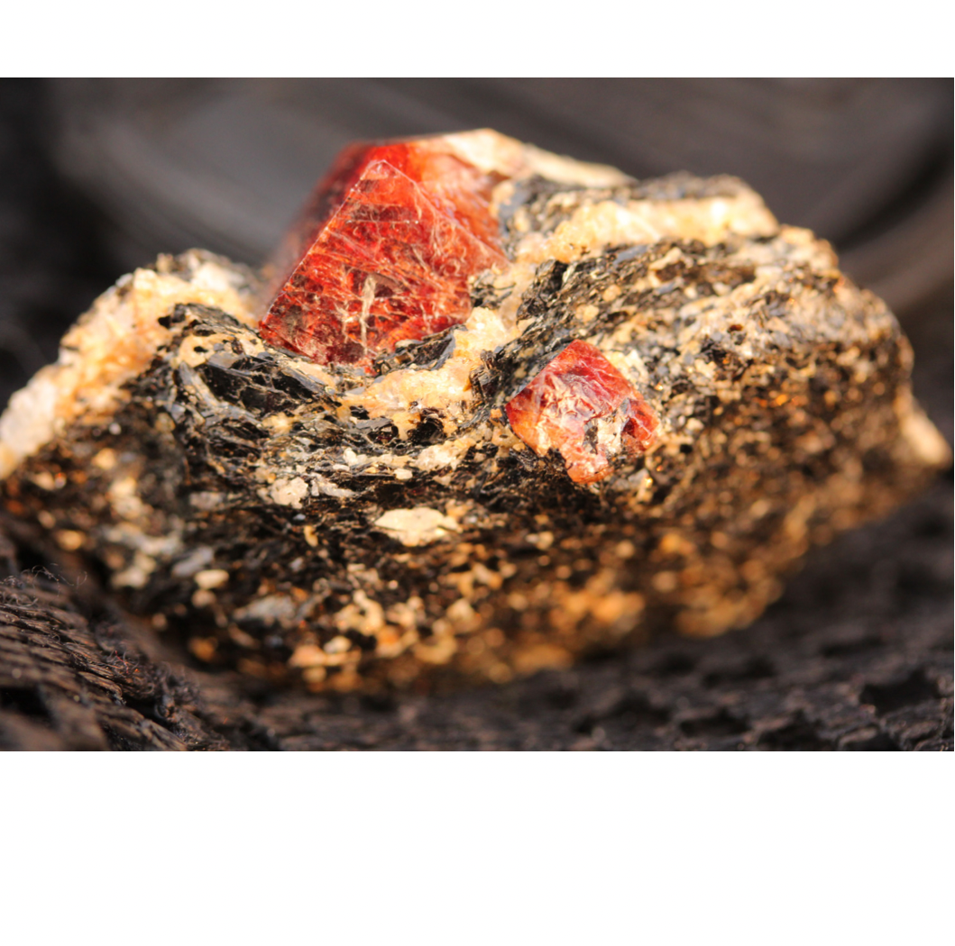 Red Zircon Crystals on Black Mica