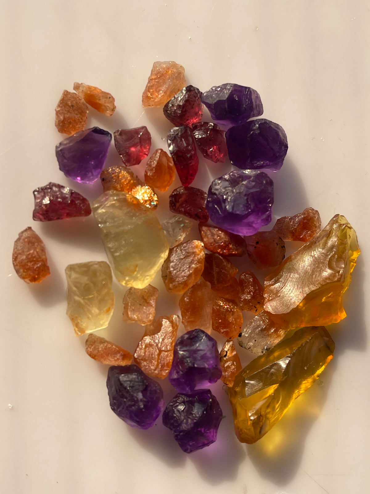 Raw stones for faceting amethyst, garnets, sunstons